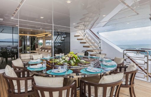 Alfresco dining set up on the main deck aft onboard charter yacht PARILLION