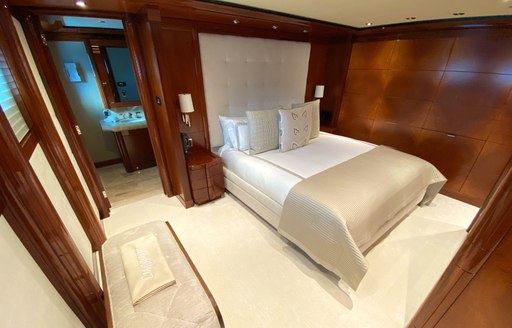 Double bed and wood panelling on superyacht Chasing Daylight