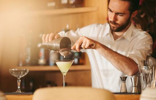 Bartender pouring cocktail at La Petite Plage