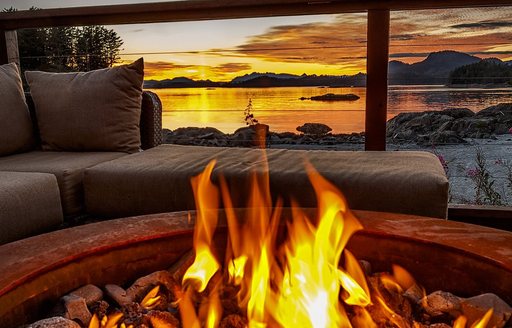 Fire on the outdoor terrace of Talon lodge and spa in Alaska