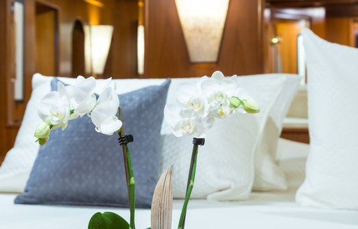 detailed shot of flower at foot of bed on motor yacht over the rainbow