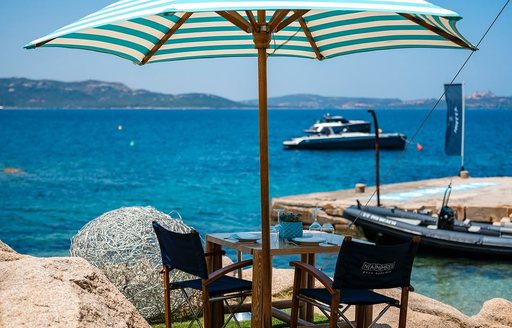 Waterside table and parasol at Nammos Baja Sardinia