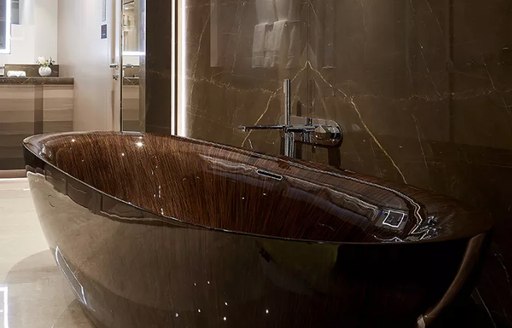 polished wood bath in bathroom of main suite on luxury yacht irisha