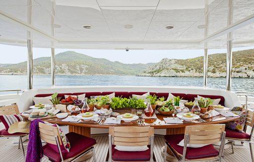 alfresco dining setup on the upper deck aft of luxury yacht Metsuyan IV