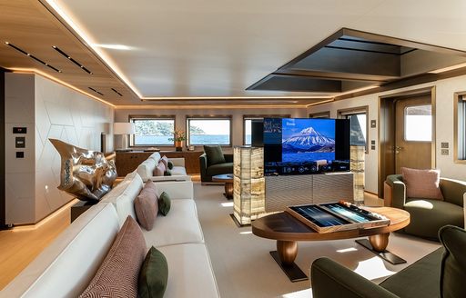 Lounge area and large TV in the main salon onboard charter yacht LA DATCHA