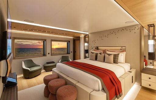 A guest cabin onboard charter yacht LA DATCHA with a forward facing berth and two windows in the background