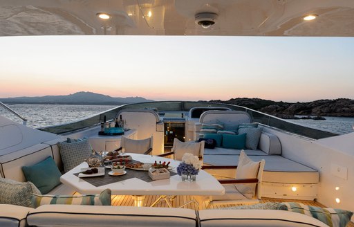 seating area and sun pads on the flybridge of motor yacht AMAYA 