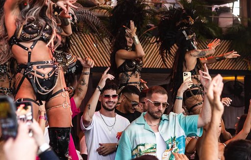 DJ set and dancers in action at YONA Beach Club