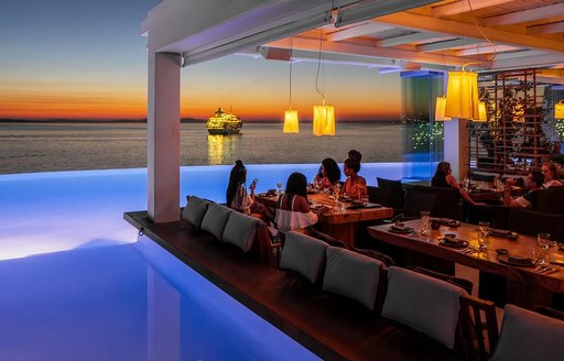 Cavo Tagoo Mykonos dining area, pool, sunset