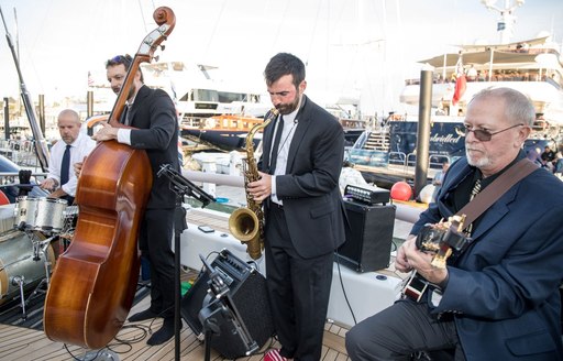 A group of musicians playing onboard a yacht at the Newport Charter Yacht Show