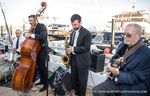A group of musicians playing onboard a yacht at the Newport Charter Yacht Show