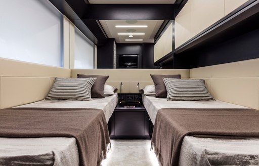 Twin beds in cabin on motor yacht BEYOND with mirror behind