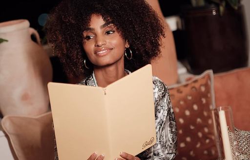 Charter guest holding a menu at Barry Club