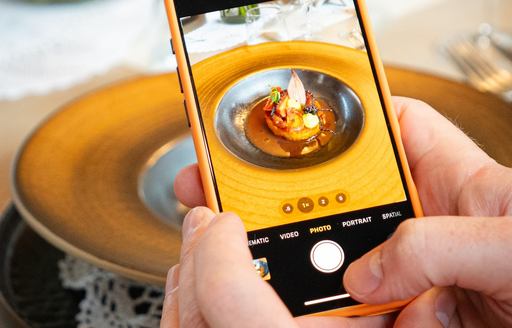 Person taking photo of superyacht cuisine