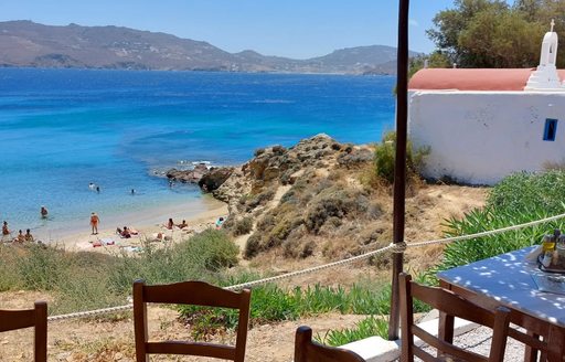 Mykonos - Agios Sostis view from cliffside tavern, chapel