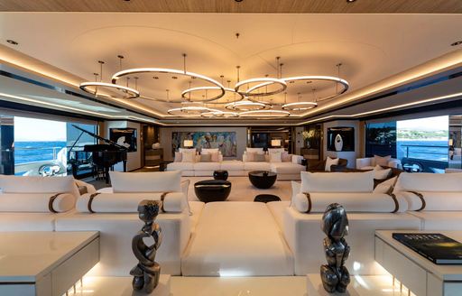 Main salon onboard luxury yacht charter PROJECT X, expansive lounge area with white seating