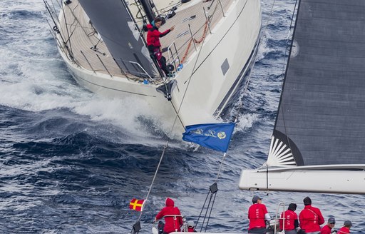 Two sailing yachts on the water off the coast of Porto Cervo, in Costa Smeralda, participating in 2019 Loro Piana Superyacht Regatta 