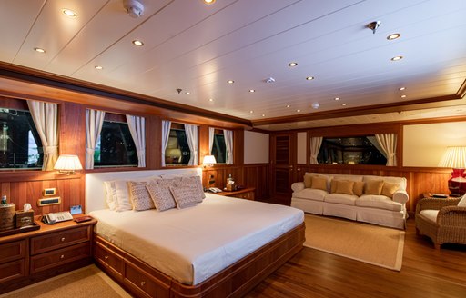 Large cabin on superyacht Bleu De Nimes with bed and sofa