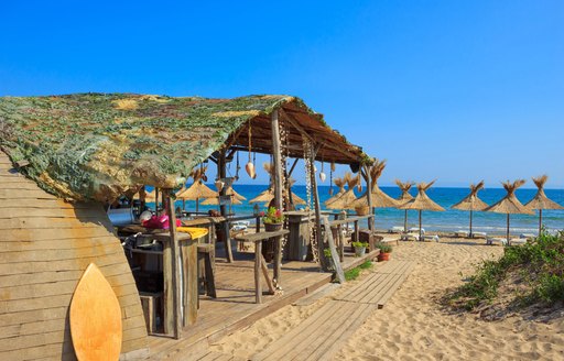 A bar on the beach with straw parasols on the island of St Barts