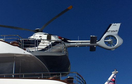 helicopter on the helipad of a superyacht lined up at FLIBS 2017