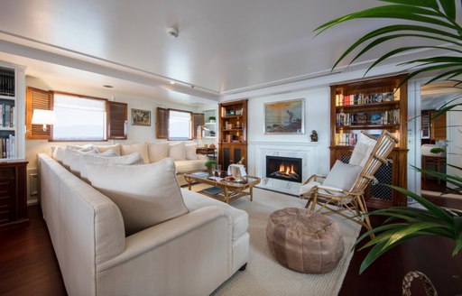 salon with fireplace and bookshelves on board charter yacht Haida 1929