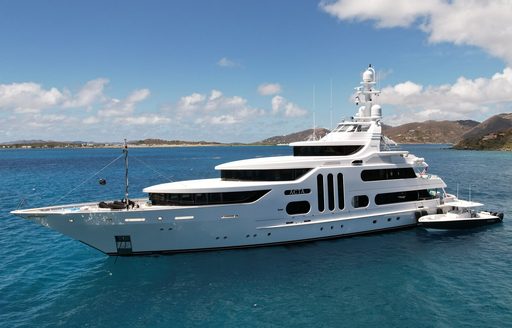 Charter yacht ACTA at anchor with tender alongside