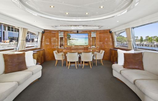 Italian-style main salon with lounge and dining table aboard charter yacht ‘Lady Pamela’ 