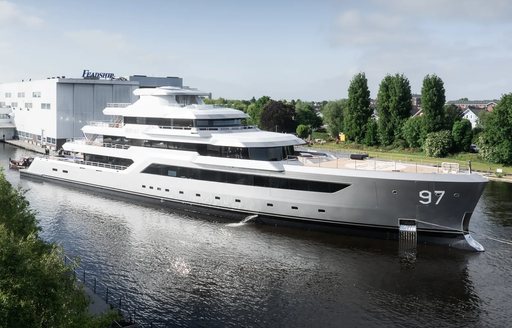 Superyacht VALOR under escort on river