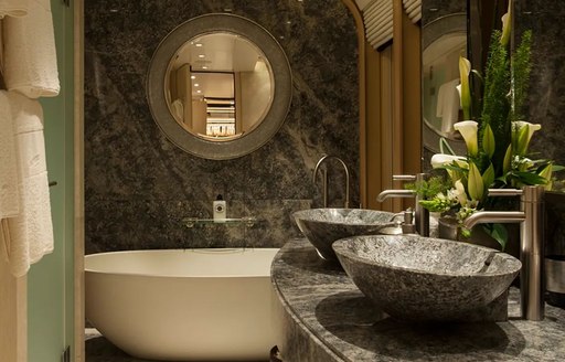 Close up of sinks and large bath on superyacht Sea Rhapsody