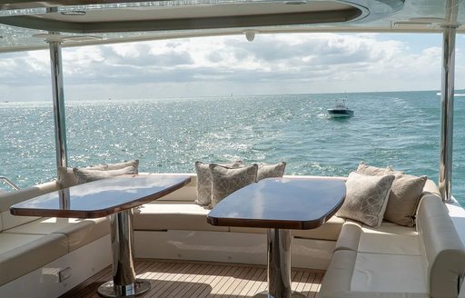 Covered table and seating on motor yacht ENTREPRENEUR