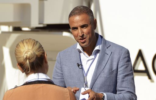 Man speaking to woman at Monaco Yacht Show 2018