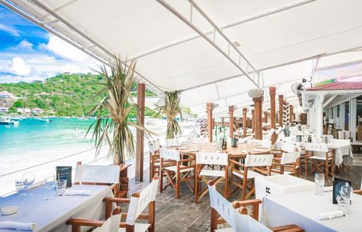 Tables and chair arranged the restaurant at Nikki Beach St Barts