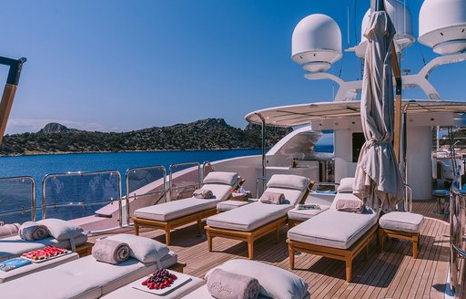 Sun loungers positioned on sun deck of charter yacht IDYLLIC