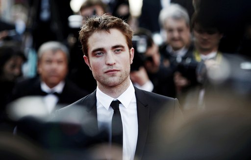 Robert Pattinson poses for photographs on the red carpet at the Cannes Film Festival 