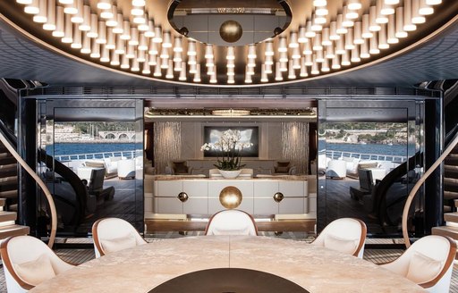 alfresco dining with glimpse of luxe interior on board luxury yacht JUBILEE