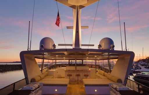 flybridge with bar and sun pads on motor yacht blackwood at sunset 