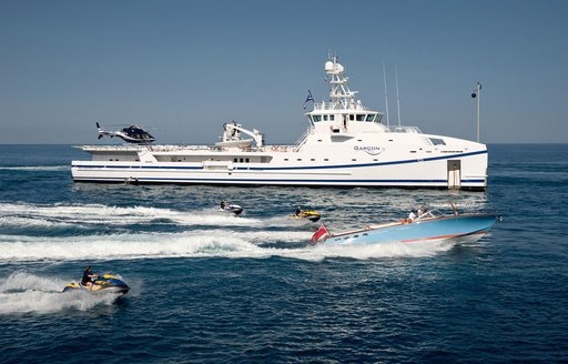 Support vessel GARCON cruises alongside tender and jet ski