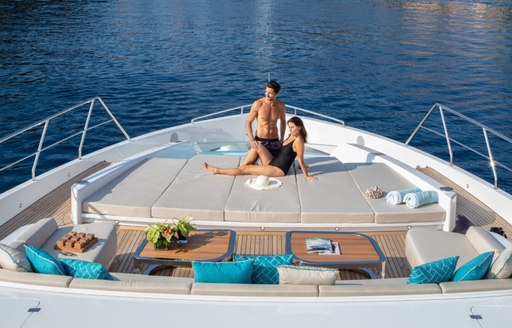 Overview of the bow onboard charter yacht Never Give Up, two charter guests enjoy the view on the sunpads 