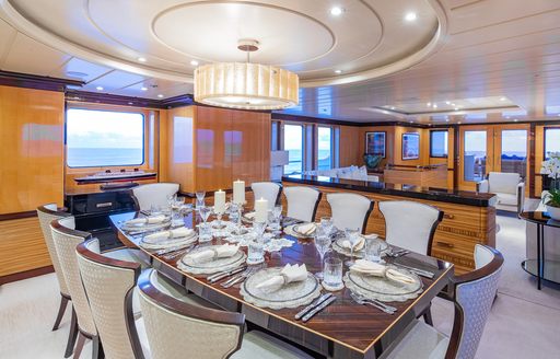 Interior dining set up in the main salon onboard charter yacht NITA K II