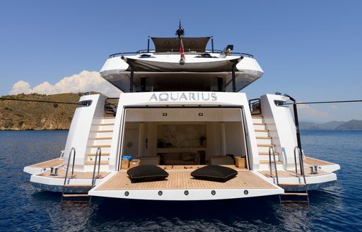 Aft view of Charter yacht AQUARIUS at anchor with her beach club open 