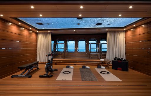 Gym equipment arranged in center of room onboard charter yacht BLACK PEARL