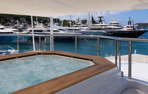 View of superyacht charters in Antigua with a deck Jacuzzi in the foreground