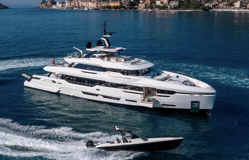 Charter yacht LEE at anchor with a tender speeding around