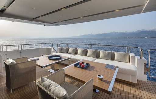 tables, chairs and sofas on the aft deck of superyacht DINAIA 