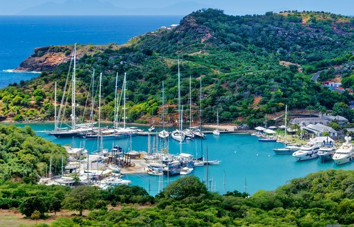 Elevated view looking down on a marina in the Caribbean surrounded by raised terrain