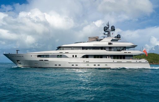 Charter yacht VIBRANCE underway with island in background
