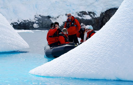Guests tender to an iceberg on charter yacht Enigma SK