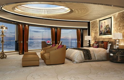 Master cabin onboard charter yacht KISMET, central berth facing forward, surrounded by large full height windows