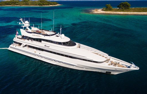 Charter yacht BRAZIL surrounded by sea with small islands in the background