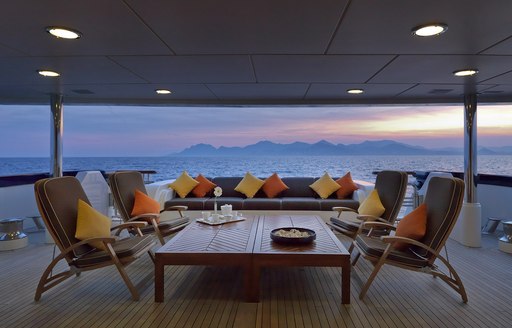 large lounging area on the main deck aft of charter yacht Deja Too